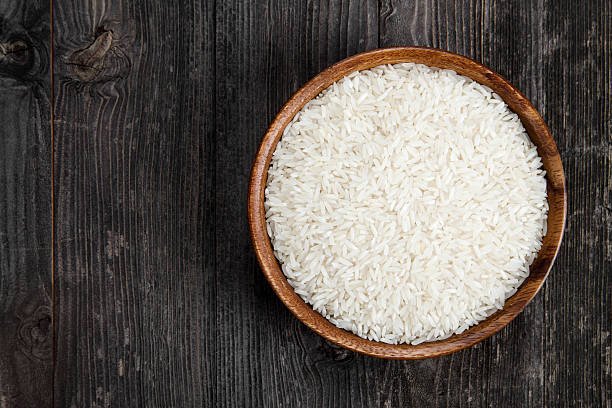 Rice in a bowl on wooden table